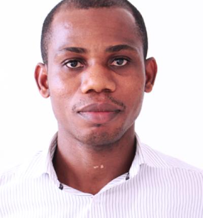 Young man wearing a light striped shirt against a plain background